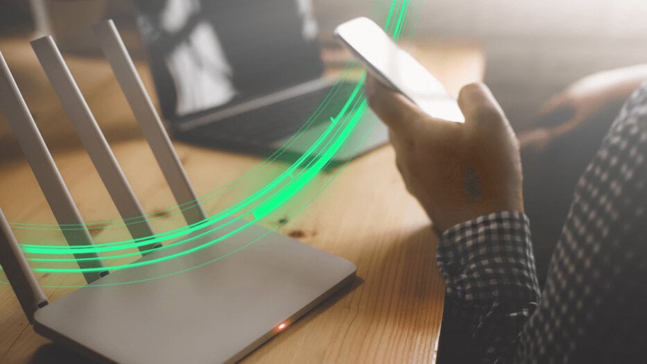 10 tips to improve your Wi-Fi signal article hero - Person checking Wi-Fi signal strength on a phone at home