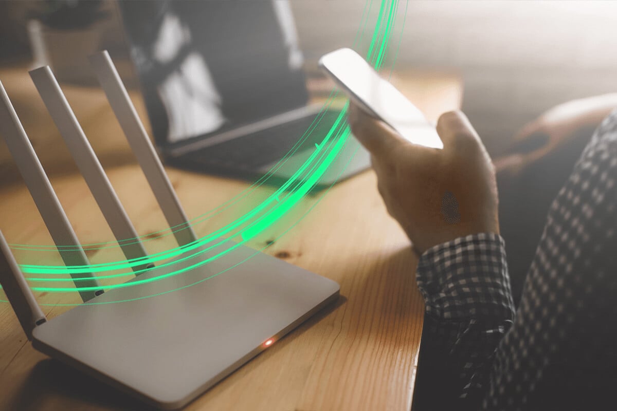 10 tips to improve your Wi-Fi signal article hero - Person checking Wi-Fi signal strength on a phone at home